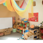 Image of colorful preschool classroom environment with learning stations and logos for Seattle DEEL and FEPP Levy