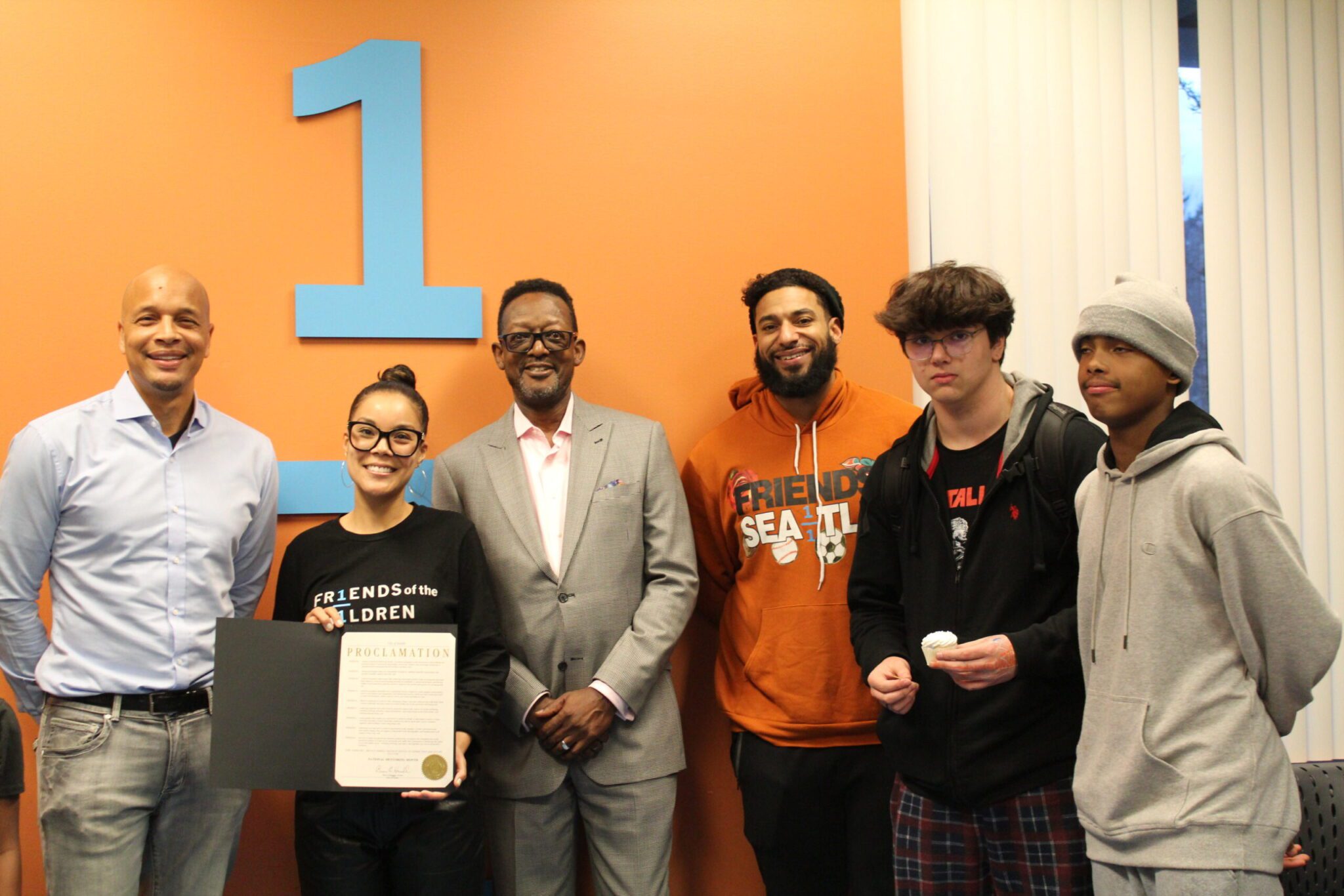DEEL Director Dr. Dwane Chappelle gathers with youth and staff at Friends of the Children-Seattle to present the 2024 National Mentoring Month Proclamation