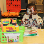 Child with learning activities and books.