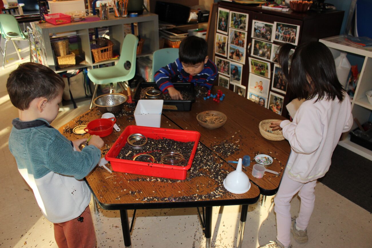 Children playing with baskets and excavation tools.