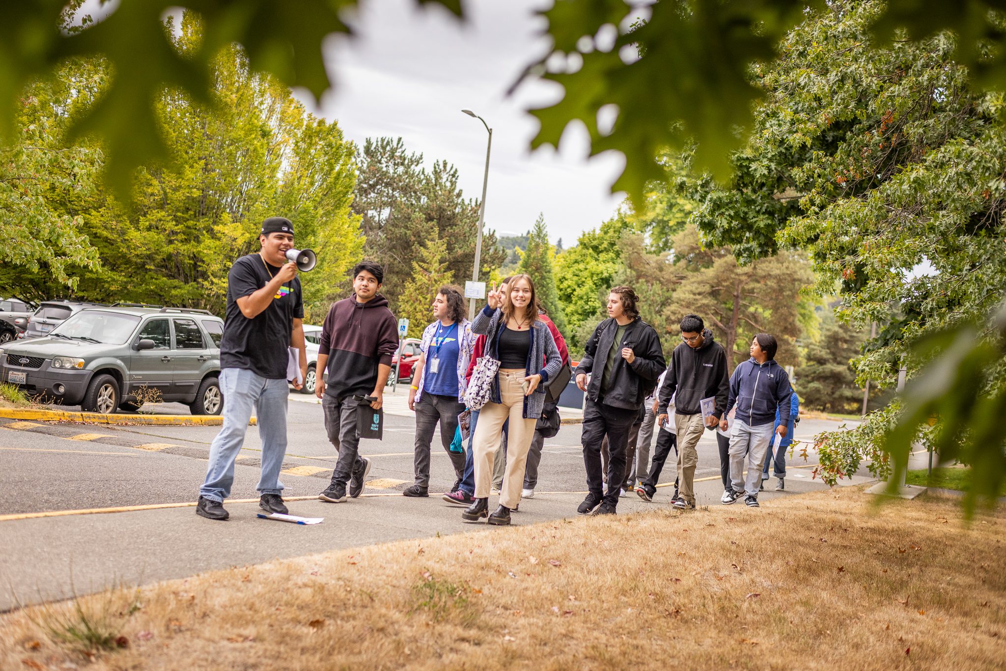 On the left, Seattle Promise Outreach Specialist Aurelio Barajas guides a group of incoming Scholars at South Seattle College for Summer Bridge 2023