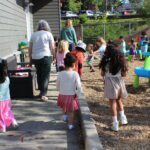 Children follow their teacher for outdoor playtime.