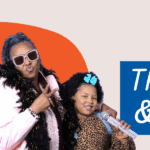 Intergenerational Black event attendees pose joyfully with photo booth props including a loudspeaker, microphone, feather boa, and sunglasses. Text overlay reads, "Thrive and Vibe."